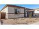 Close up showcasing desert landscaping and the exterior finishes of this elegant single-story home at 15846 W Bronco Trl, Surprise, AZ 85387