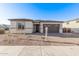 Charming single-story home with a manicured front yard and brick driveway at 15846 W Bronco Trl, Surprise, AZ 85387