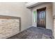 Inviting front door with stone veneer accents and decorative pavers, adding curb appeal at 15846 W Bronco Trl, Surprise, AZ 85387