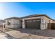 Inviting one-story home featuring low-maintenance desert landscaping and an attached two-car garage at 15846 W Bronco Trl, Surprise, AZ 85387