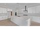 Bright, modern kitchen with white cabinets, stainless steel appliances, and a large center island at 15846 W Bronco Trl, Surprise, AZ 85387