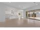 Open-concept living space with tile floors seamlessly connecting the kitchen and living areas at 15846 W Bronco Trl, Surprise, AZ 85387