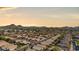 This aerial view showcases the neighborhood, the home's tile roof and the surrounding desert landscape at 16424 N 1St Dr, Phoenix, AZ 85023