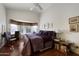Comfortable bedroom with wood floors, a large window, and a cozy reading corner at 16424 N 1St Dr, Phoenix, AZ 85023