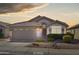 Charming single-story home with a well-maintained front yard and a two-car garage at sunset at 16424 N 1St Dr, Phoenix, AZ 85023