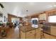 Open-concept kitchen with a large island, stainless appliances, and a view of the living area at 16424 N 1St Dr, Phoenix, AZ 85023