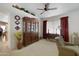This living room features a ceiling fan, carpeted floor, and a hutch at 16424 N 1St Dr, Phoenix, AZ 85023