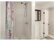 Bright bathroom features a shower, floral curtain, and black cabinet at 16833 N 17Th Pl, Phoenix, AZ 85022