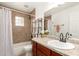 Bathroom featuring tiled shower, granite countertop, and ample lighting at 16833 N 17Th Pl, Phoenix, AZ 85022