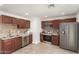 Well-equipped kitchen featuring stainless steel appliances, tile backsplash, and dark wood cabinets at 16833 N 17Th Pl, Phoenix, AZ 85022
