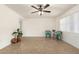 Bright living room featuring neutral tile flooring, ceiling fan, and ample natural light at 16833 N 17Th Pl, Phoenix, AZ 85022