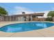 Backyard with a sparkling blue swimming pool and covered patio at 16833 N 17Th Pl, Phoenix, AZ 85022