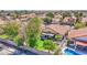 High-angle view of a house highlighting the well-kept lawn, patio, pool, and the surrounding neighborhood at 1702 W Mercury Way, Chandler, AZ 85224