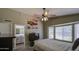 Comfortable main bedroom with a bay window, ceiling fan, and an ensuite bathroom entrance at 1702 W Mercury Way, Chandler, AZ 85224