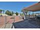 Large backyard featuring low maintenance rock landscaping, a shed and a covered patio with furniture at 17244 N 66Th Ln, Glendale, AZ 85308