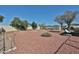 View of large backyard featuring rock landscaping and a shed at 17244 N 66Th Ln, Glendale, AZ 85308