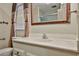 Bathroom featuring a single vanity, large mirror, and window, providing a functional and bright space at 17244 N 66Th Ln, Glendale, AZ 85308