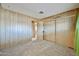 Bright, airy bedroom with carpeting, a large closet, and adjacent doorway to a bathroom at 17244 N 66Th Ln, Glendale, AZ 85308
