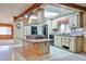 Bright kitchen with island cooktop, neutral cabinetry, black appliances and open floor plan at 17244 N 66Th Ln, Glendale, AZ 85308