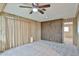 Bright living area with neutral carpet, wood paneled walls and sliding door to patio at 17244 N 66Th Ln, Glendale, AZ 85308