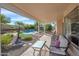 Relaxing back patio with comfortable seating and a view of the sparkling pool and lush landscaping at 17631 N 42Nd Dr, Glendale, AZ 85308