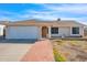 Charming single-story home featuring a well-manicured lawn, neutral colors and a two-car garage at 17631 N 42Nd Dr, Glendale, AZ 85308