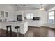 Bright kitchen with white cabinets, stainless appliances, an island with seating, and hardwood floors at 17631 N 42Nd Dr, Glendale, AZ 85308