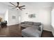 Cozy living area featuring comfortable gray sofa and hardwood flooring at 17631 N 42Nd Dr, Glendale, AZ 85308