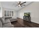 Comfortable living room with a grey sofa, plantation shutters and hardwood floors at 17631 N 42Nd Dr, Glendale, AZ 85308