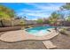 Inviting pool surrounded by a stone patio and lush landscaping at 17631 N 42Nd Dr, Glendale, AZ 85308
