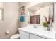 Bathroom featuring a white vanity, framed mirror, and patterned shower curtain at 17845 W Red Fox Rd, Surprise, AZ 85387