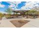 Neighborhood gazebo with picnic tables, desert landscaping, and a manicured lawn at 17845 W Red Fox Rd, Surprise, AZ 85387