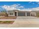 Charming single-story home with a three-car garage and stone accents at 17845 W Red Fox Rd, Surprise, AZ 85387
