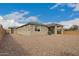 The home's backyard includes a covered patio with desert landscaping at 17845 W Red Fox Rd, Surprise, AZ 85387