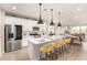Modern eat-in kitchen featuring a central island, stainless steel appliances, and wood floors at 17845 W Red Fox Rd, Surprise, AZ 85387