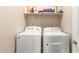 Laundry room featuring a side-by-side washer and dryer with shelf storage above at 17845 W Red Fox Rd, Surprise, AZ 85387