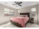 Calm primary bedroom featuring a ceiling fan and neutral color scheme at 17845 W Red Fox Rd, Surprise, AZ 85387