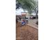 Spacious backyard showing a patio area, lots of storage and some clutter at 18293 W Elm St, Surprise, AZ 85388