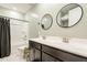 Bathroom featuring dual sinks, modern fixtures, and a shower-tub combination, providing convenience and style at 20237 W Palo Verde Dr, Litchfield Park, AZ 85340