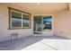 Covered patio provides an outdoor entertaining area with an adjacent window and sliding door at 20237 W Palo Verde Dr, Litchfield Park, AZ 85340