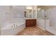 This elegant bathroom features a tub, shower, and modern fixtures for a spa-like experience at 21008 W Cora Vis, Buckeye, AZ 85396