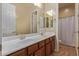 Bathroom showcasing double sinks, spacious countertop, and vanity with wood cabinets at 21008 W Cora Vis, Buckeye, AZ 85396