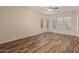 Spacious bedroom with wood flooring, large windows, and ceiling fan offering comfort and natural light at 21008 W Cora Vis, Buckeye, AZ 85396