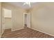 Bedroom with vinyl flooring, closet, and neutral walls, offering a versatile space at 21008 W Cora Vis, Buckeye, AZ 85396