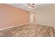 Spacious bedroom featuring wood-look flooring, a ceiling fan, and neutral wall colors at 21008 W Cora Vis, Buckeye, AZ 85396