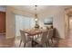 Cozy dining room featuring a wood table, seating for six, and a modern chandelier for elegant meals at 21008 W Cora Vis, Buckeye, AZ 85396