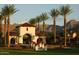 Inviting entrance flanked by palm trees and lush landscaping with mountain views at 21008 W Cora Vis, Buckeye, AZ 85396