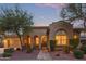 Charming single-story home with desert landscaping and a brick walkway leading to the arched entrance at 21008 W Cora Vis, Buckeye, AZ 85396