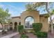 Inviting home exterior with brick walkway and meticulous landscaping with a view of the arched doorway at 21008 W Cora Vis, Buckeye, AZ 85396