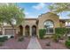 Inviting home exterior with brick walkway and meticulous landscaping with a view of the arched doorway at 21008 W Cora Vis, Buckeye, AZ 85396